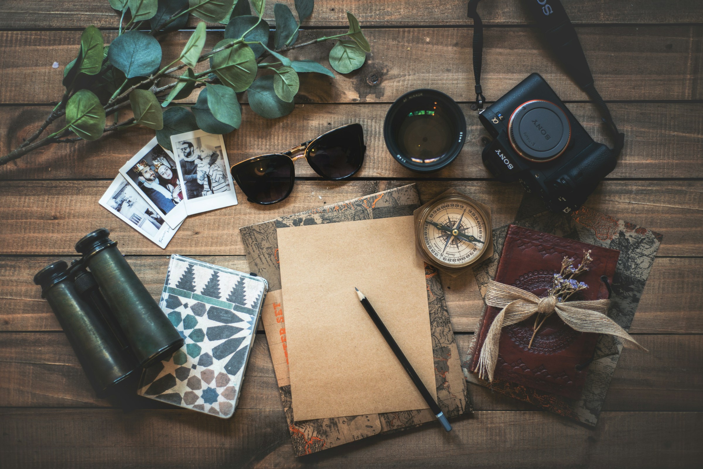 A notebook, camera and compass ready for a new journey