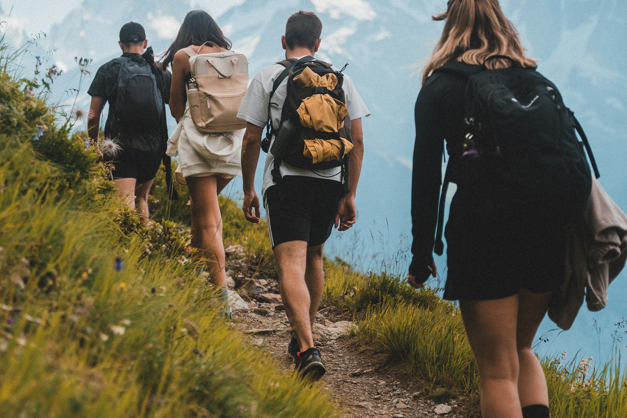 Travellers sharing a hike along a mountain trail