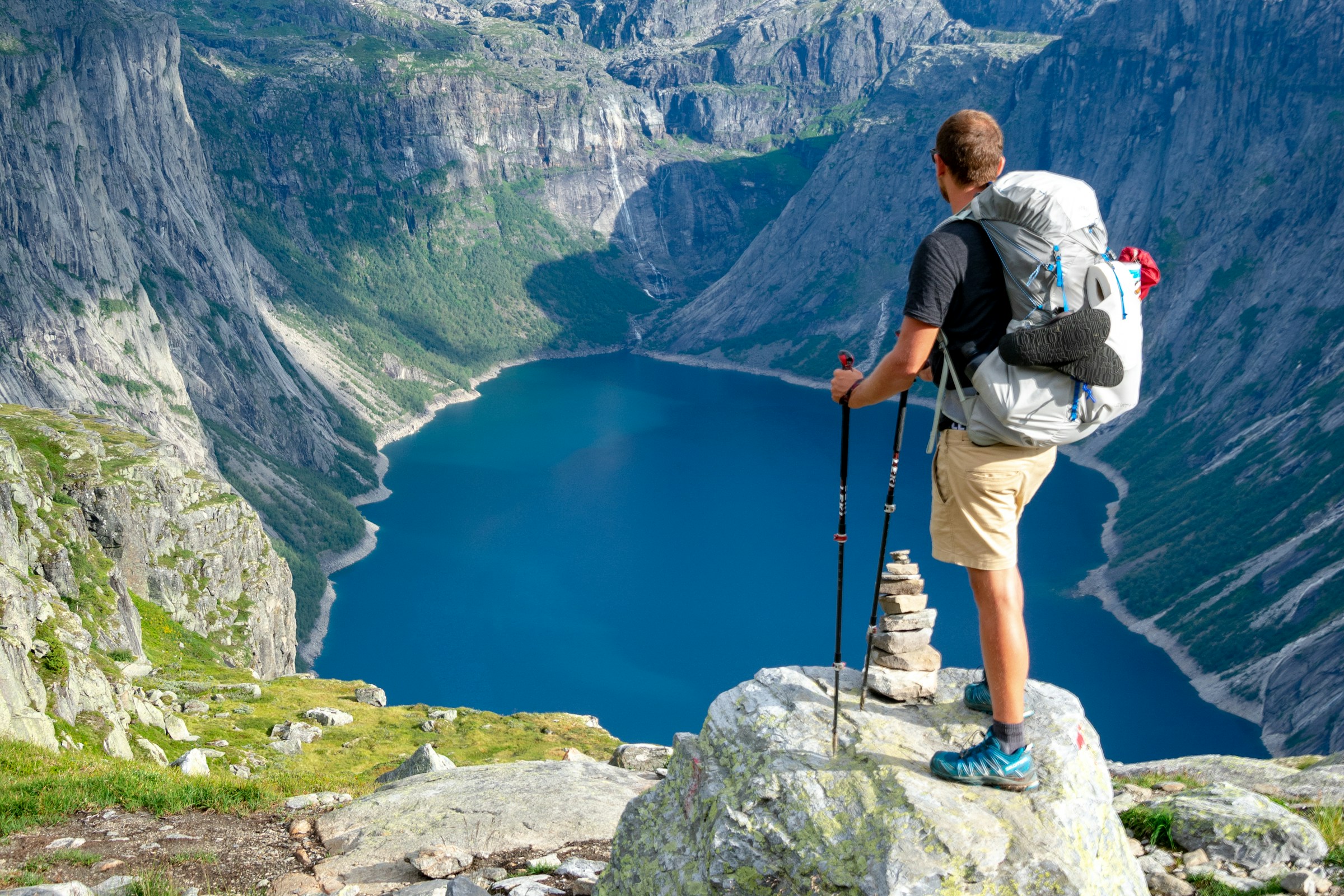 A solo hiker looking across a dramatic mountain valley