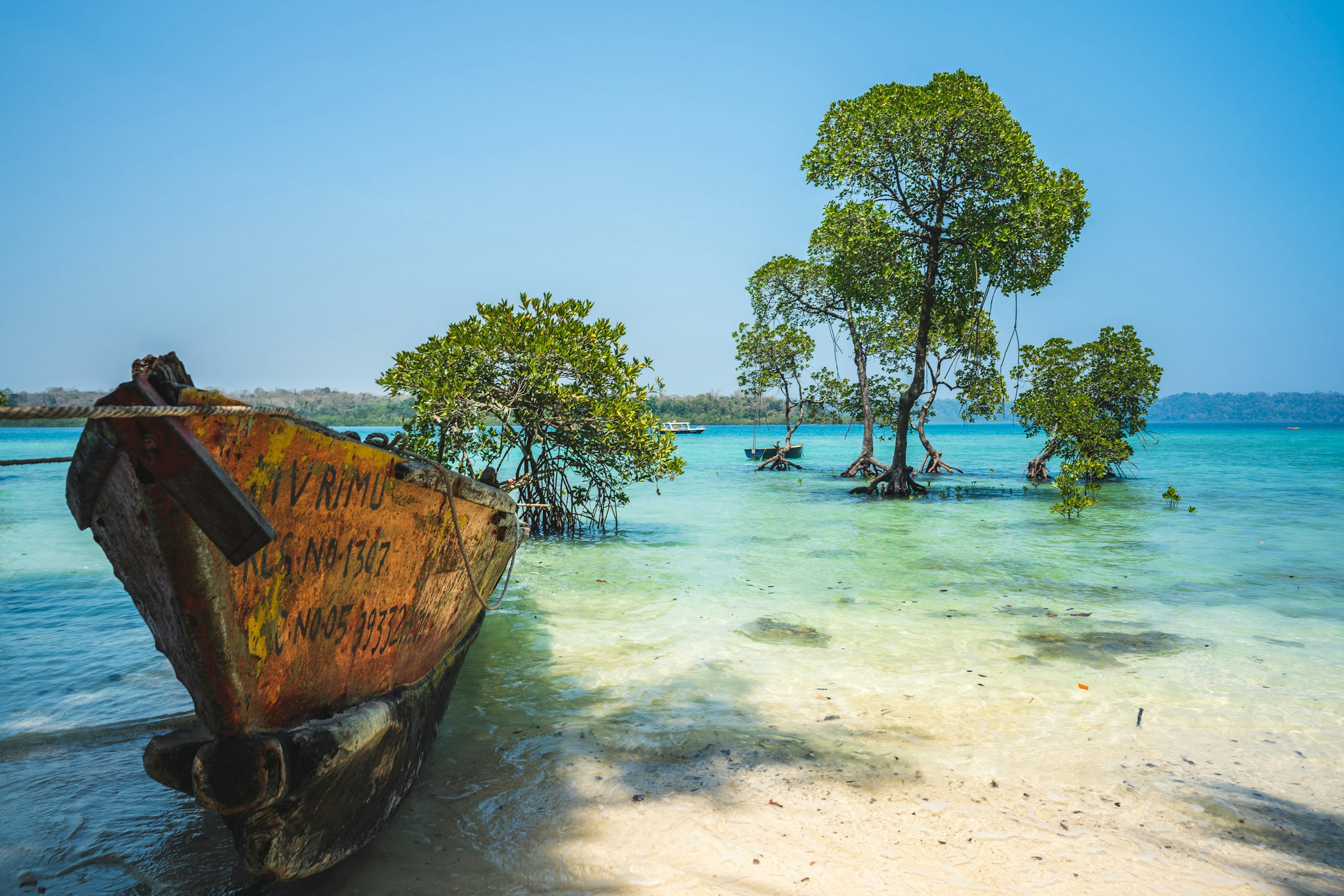 Clear turquoise shallows beside the Andaman shoreline