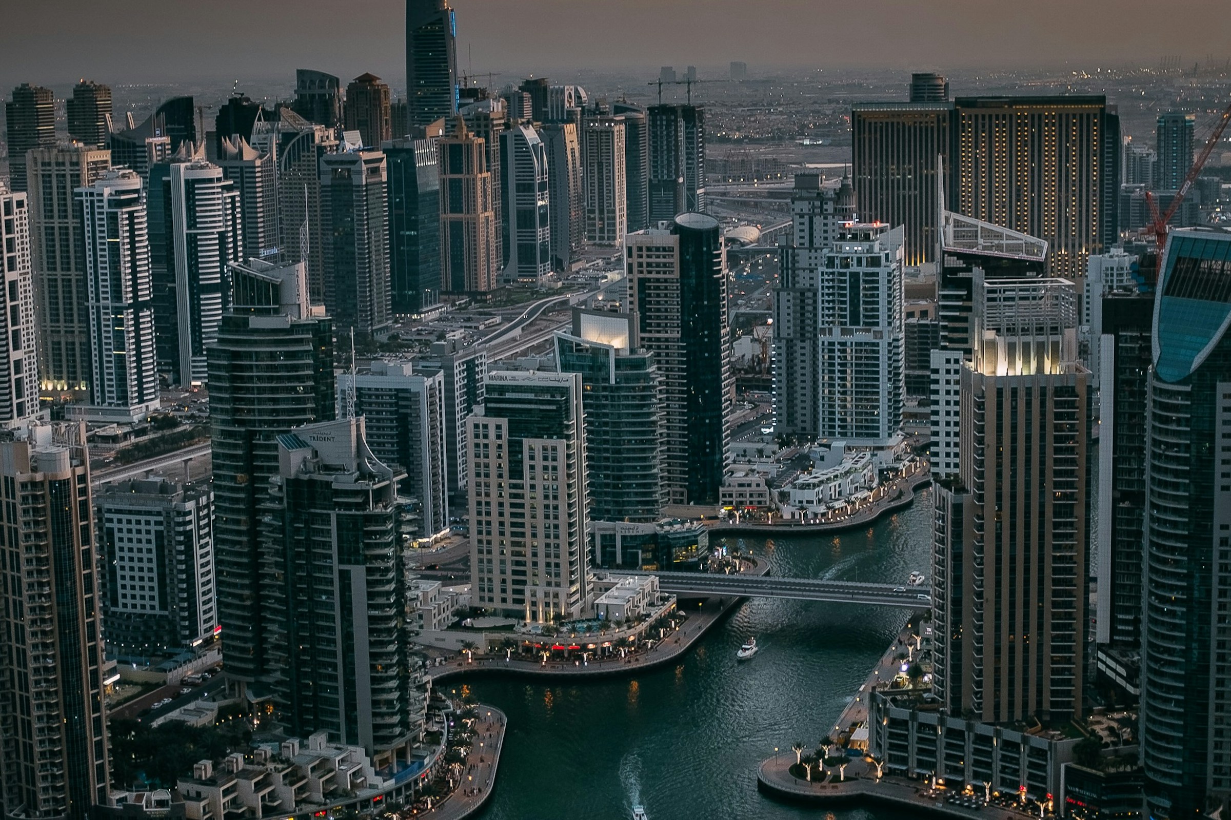 Dubai Marina and its illuminated skyline at dusk