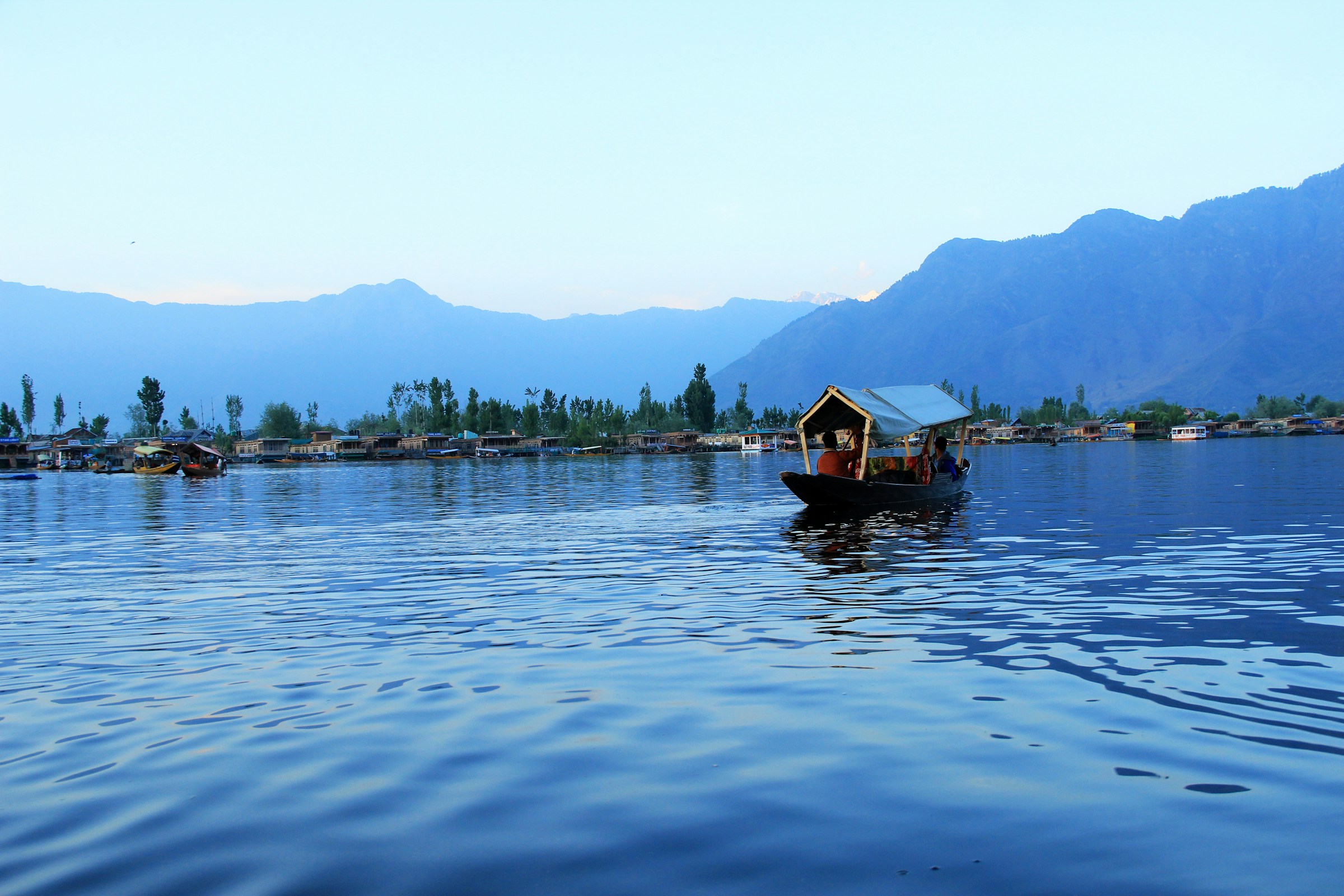 A wooden boat on the blue waters of Dal Lake, Srinagar