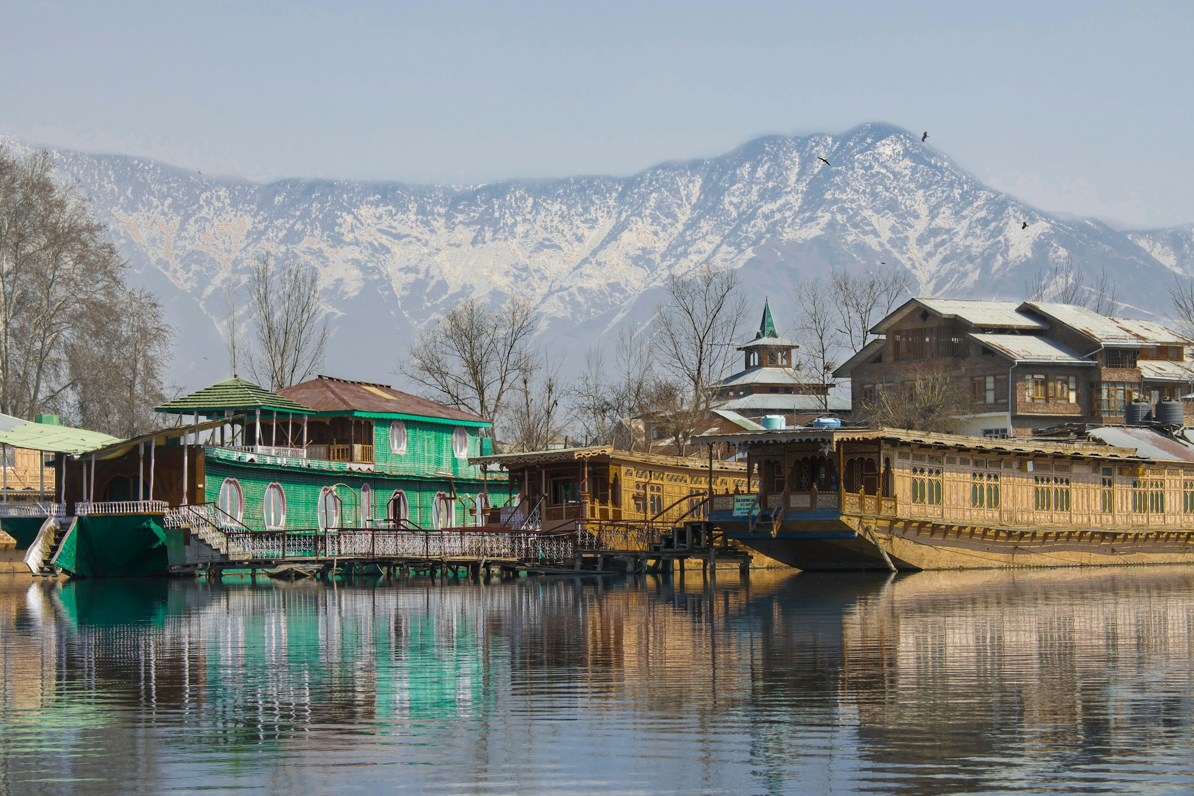Lakeside houses reflected in the calm waters of Kashmir
