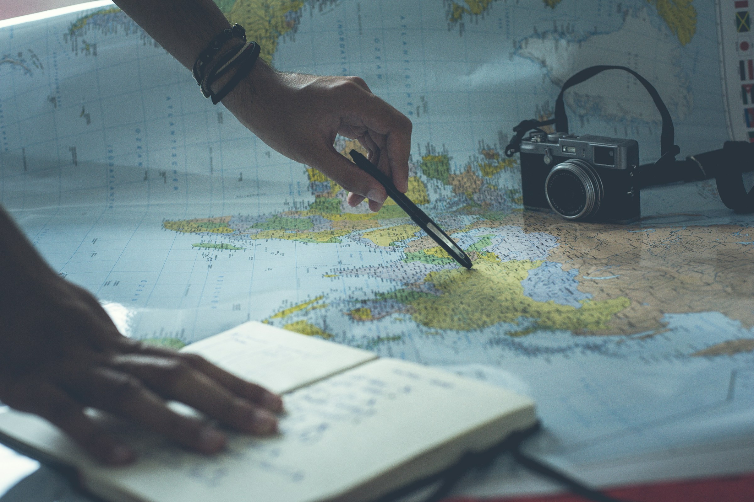 A traveller planning a route with a map and notebook