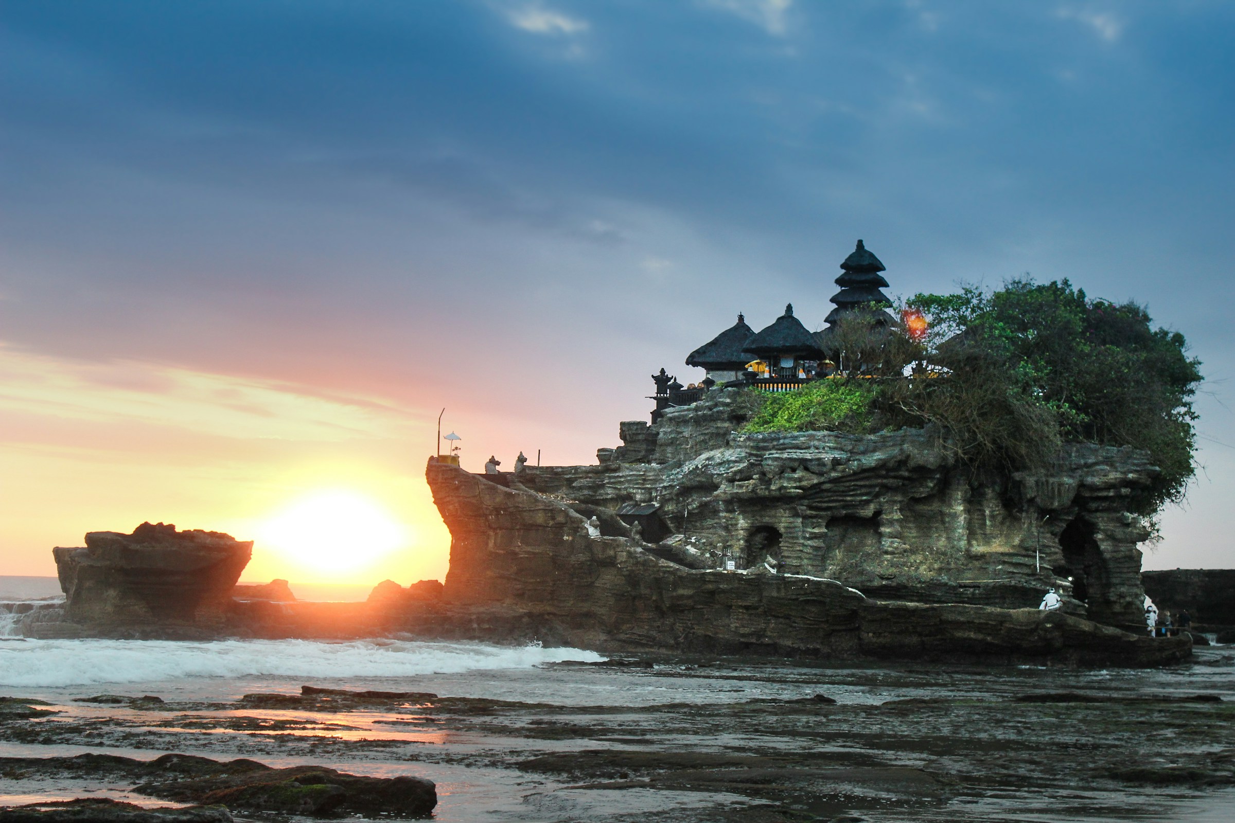 A temple on Bali's rocky coast at sunset